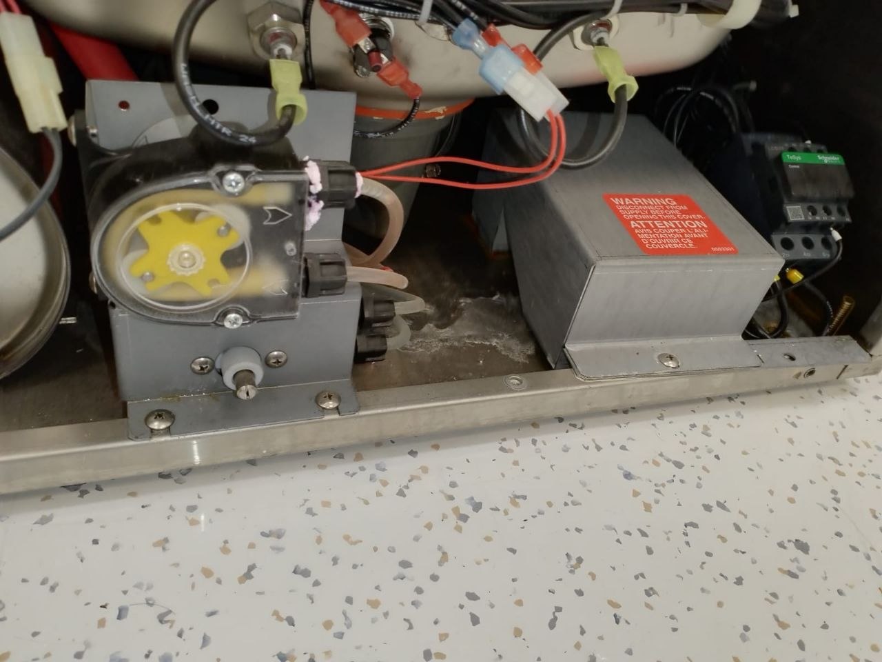 Chemical feed pump and electrical contactor inside a commercial dishwasher