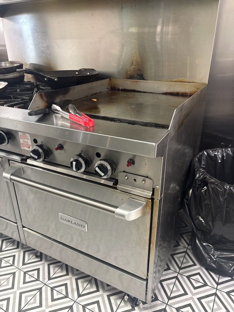 Commercial gas range and griddle serviced for a local restaurant kitchen