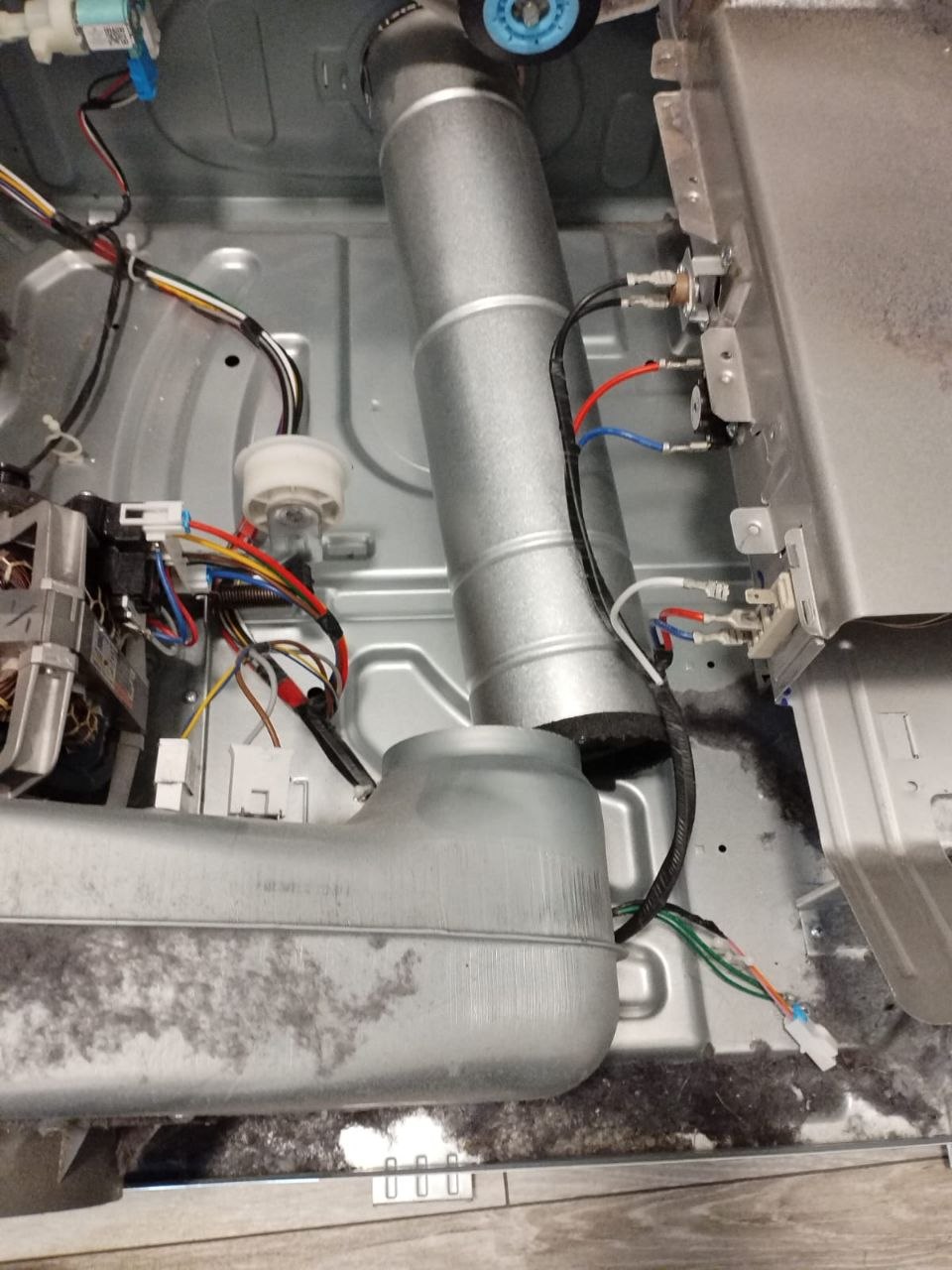 Dryer cabinet opened to inspect the exhaust duct, heater wiring and lint buildup