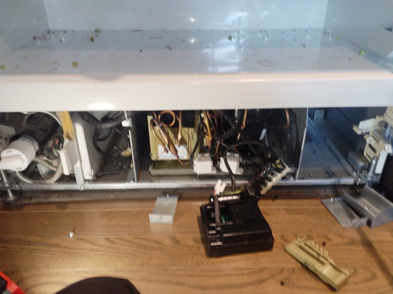 Refrigerator base opened with the compressor compartment and control board removed