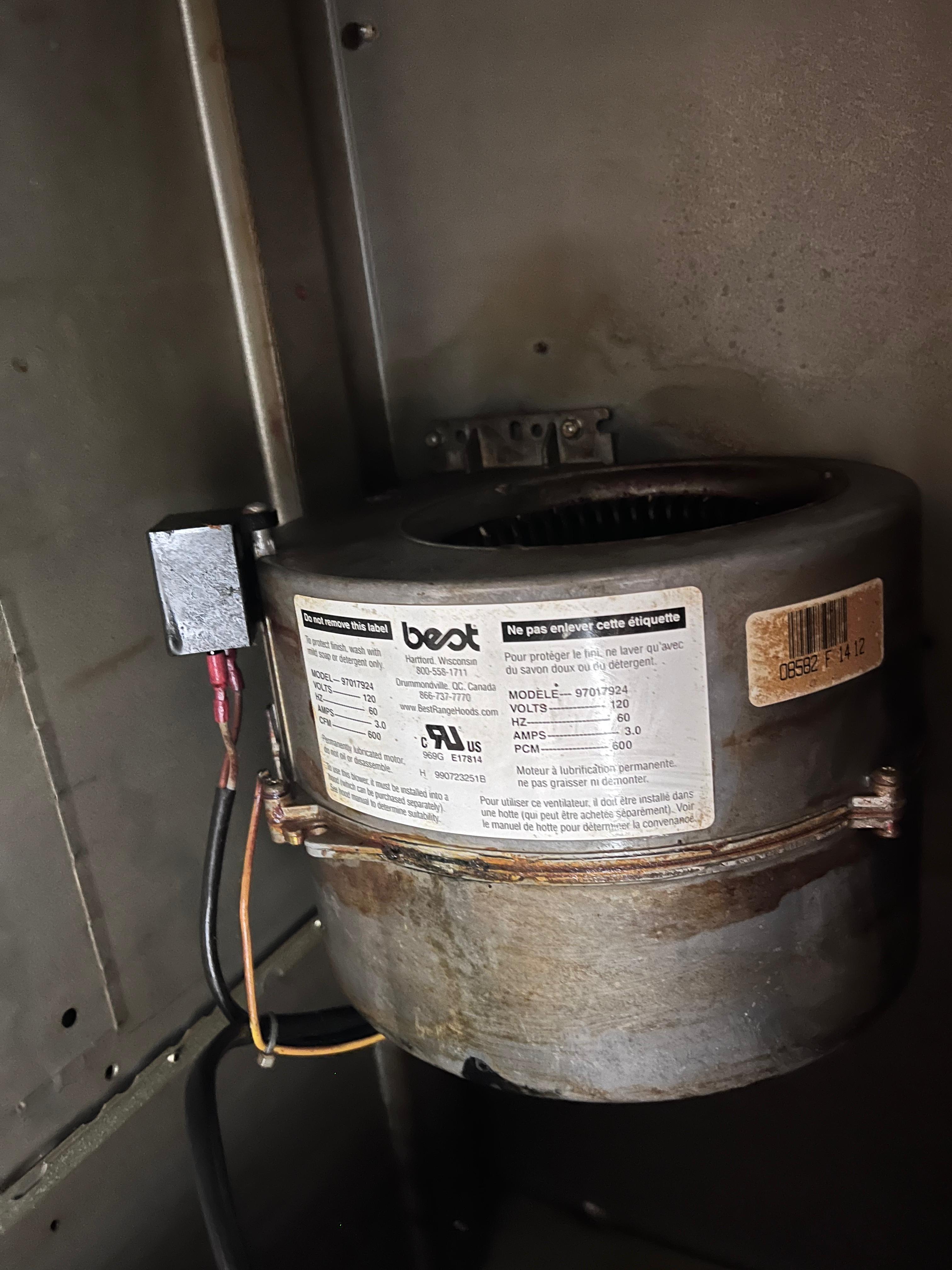Clamp meter reading amperage on a refrigerator compressor