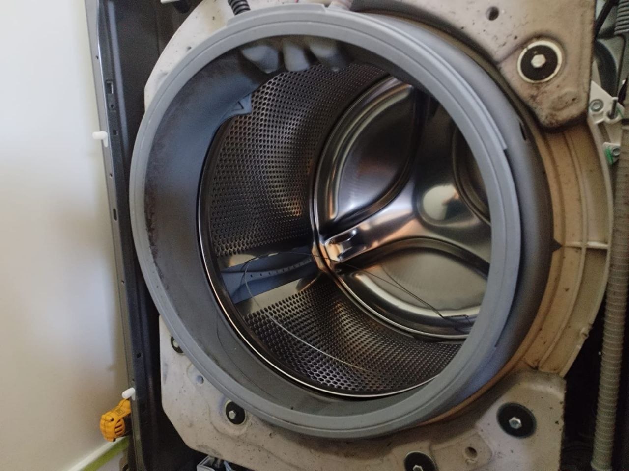 Front-load washer with the door boot seal removed to inspect the drum