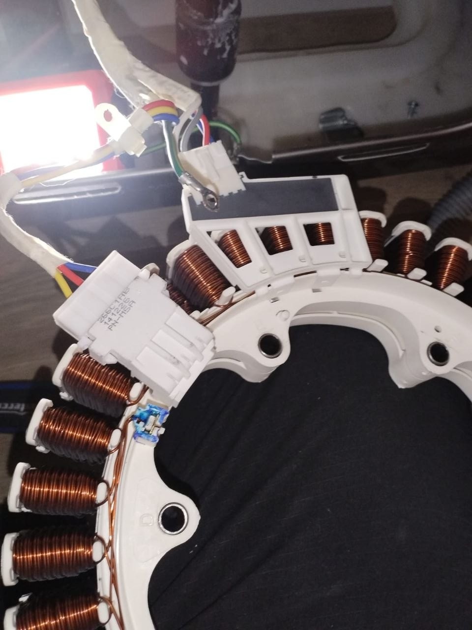 Direct-drive washer motor stator with copper windings during inspection